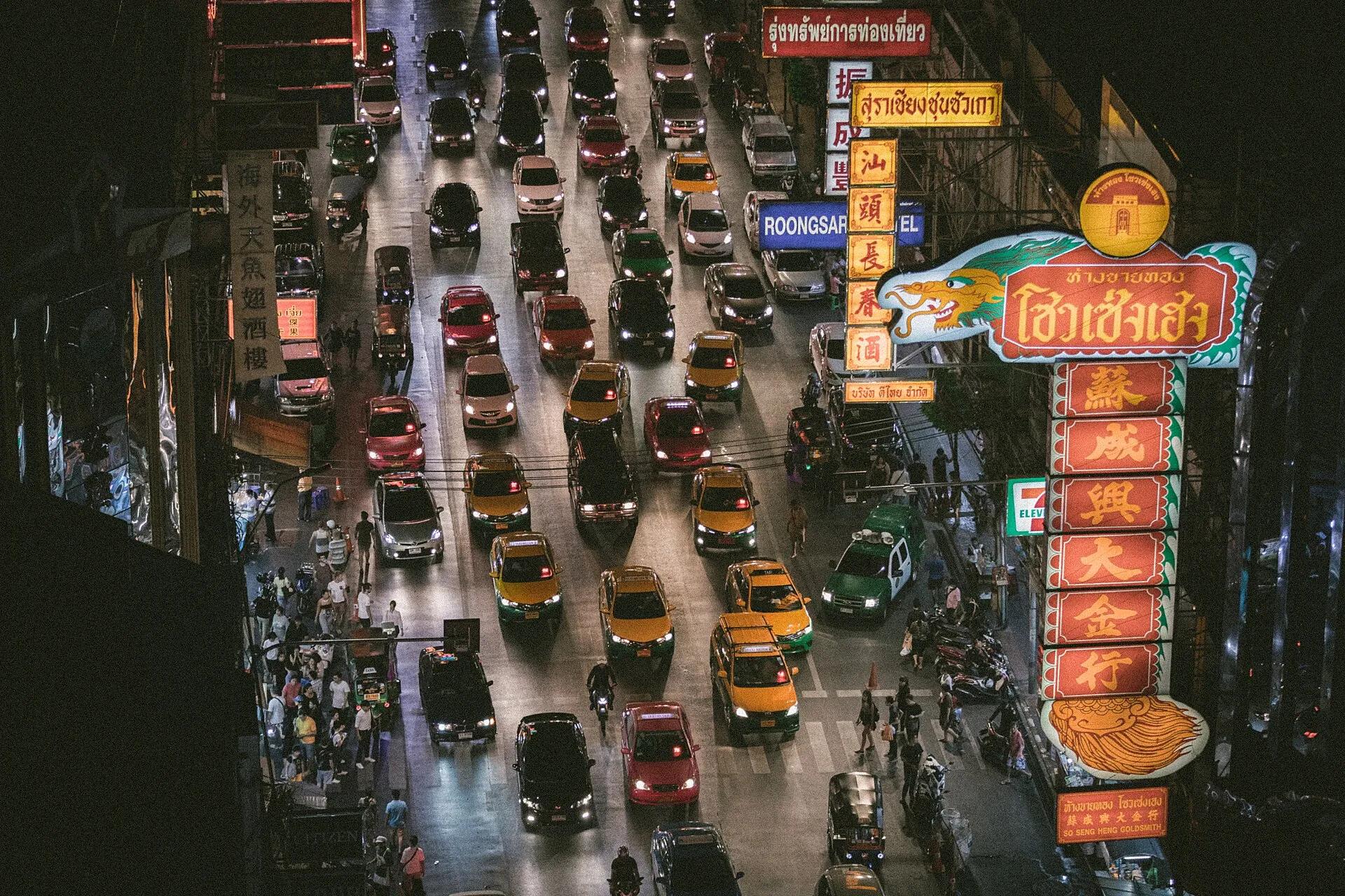 Traffic and neon signs on Yaowarat Road in Bangkok's Chinatown at night
